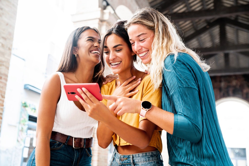 Women crowded around phone laughing