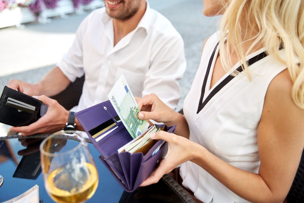 A couple spending money on a fancy lunch.