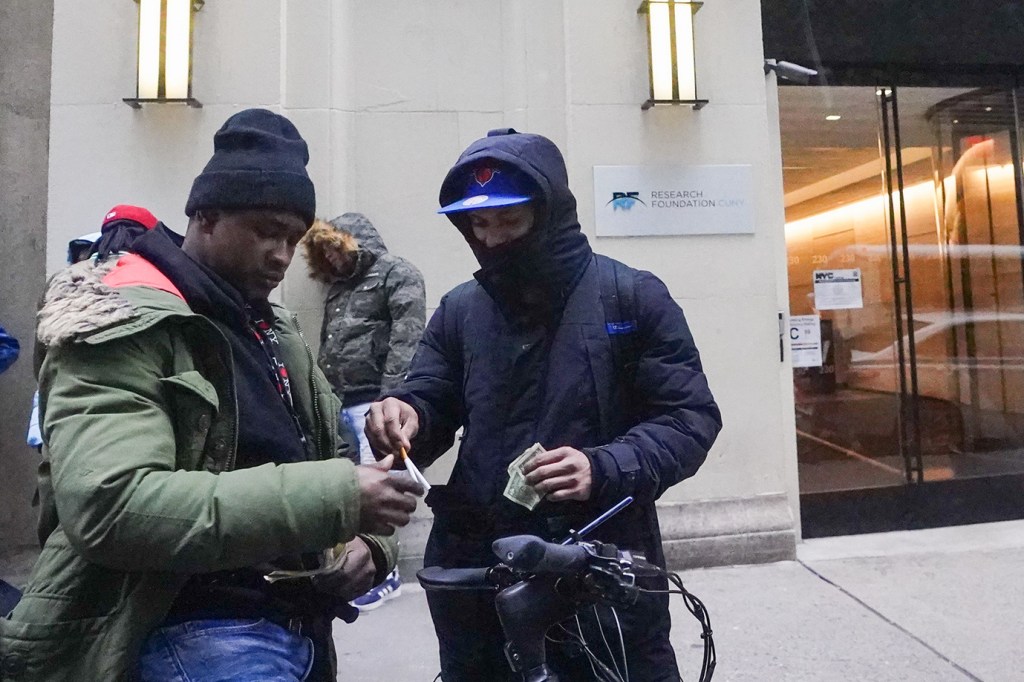 Migrants outside Midtown shelter. 