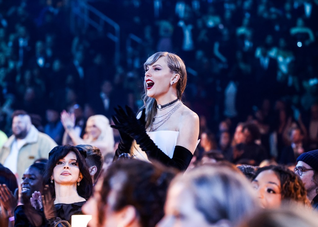 Taylor Swift applauding Trevor Noah at the 66th Grammy Awards Sunday night at the Crypt