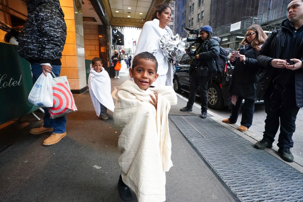 Migrants depart Roosevelt Hotel, walk around the corner where they boarded a city bus that left shortly thereafter.