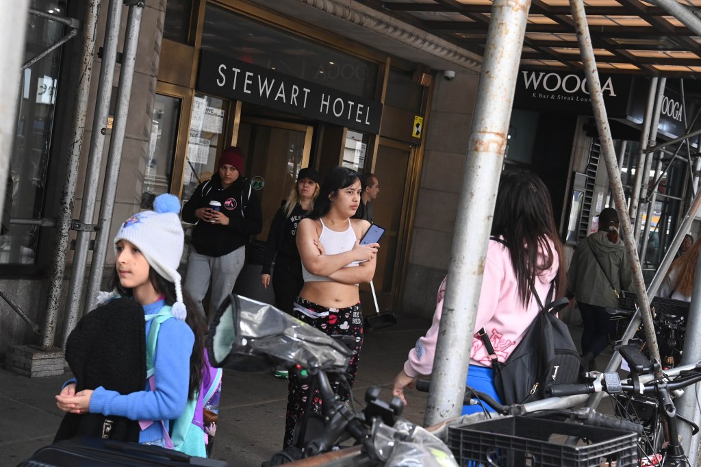 Migrants outside the Stewart Hotel on 7th Ave. and West 31st St