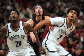 Miami Heat guard Jaime Jaquez Jr. (11) battles for position with Brooklyn Nets forward Dorian Finney-Smith (28) and forward Cameron Johnson (2) in the first half at Kaseya Center.