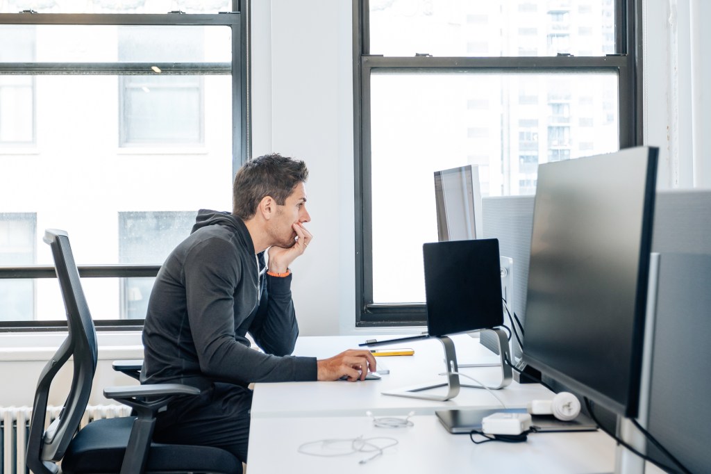 A man sitting at a desk within the headquarters of Eight Sleep in the Flatiron District of Manhattan on June 17, 2024.