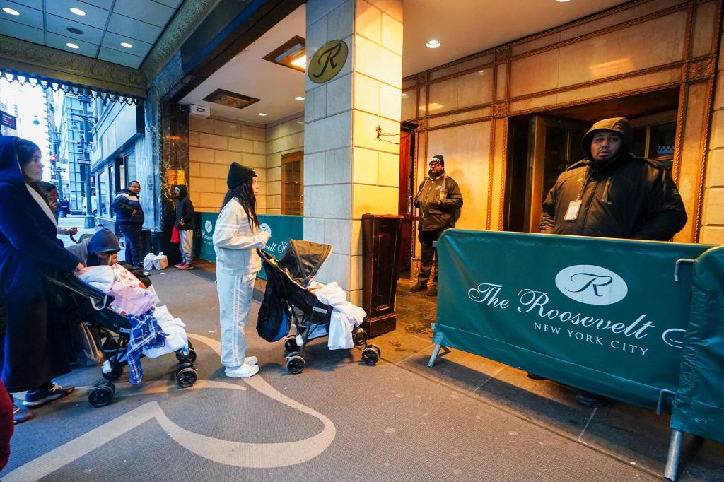 Migrants entering the shelter at the Roosevelt Hotel in Manhattan.