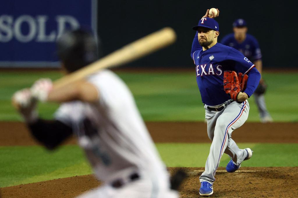 Texas Rangers starting pitcher Nathan Eovaldi (17) throws a pitch against the Arizona Diamondbacks during the sixth inning in game five of the 2023 World Series at Chase Field.