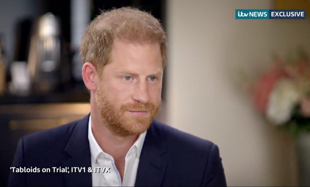 Prince Harry, Duke of Sussex, in a suit during an ITV News interview discussing his victory in a High Court case against Mirror Group Newspapers