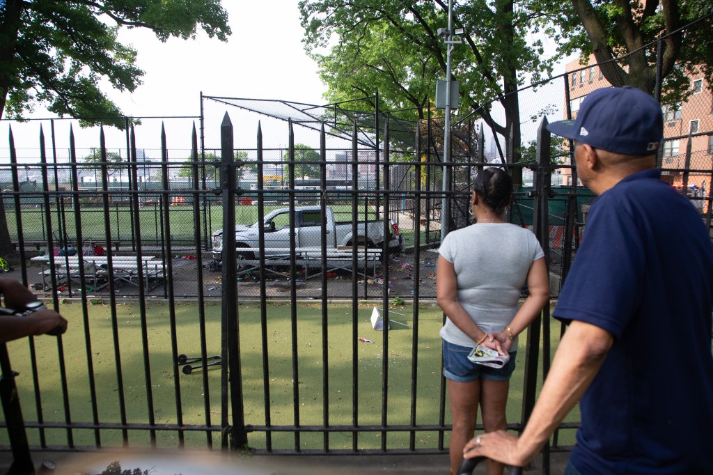 Friends of the victims observing the scene of a fatal accident in Corleone Hook Park on 4th of July