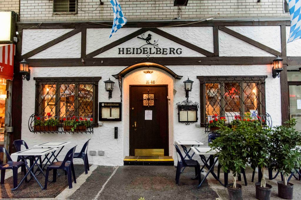 Exterior view of Heidelberg German restaurant, a circa-1936 establishment in Yorkville, New York, with visible tables and chairs