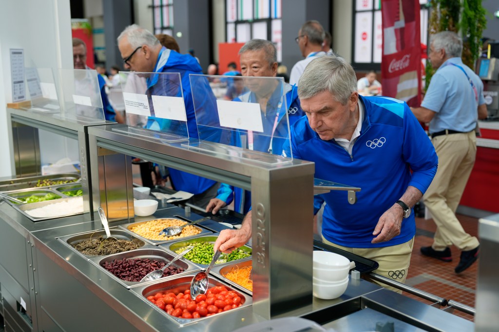 IOC President Thomas Back takes food from the Olympic Village on July 22, 2024.