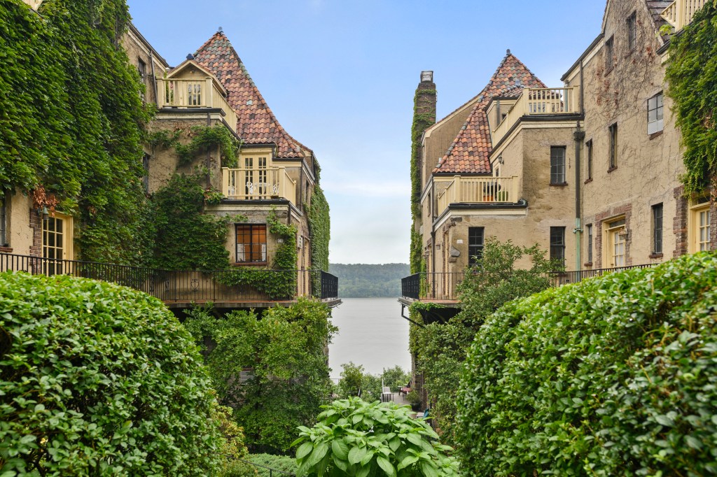 A group of buildings, identified as Villa Charlotte Brontë on 2501 Palisade Avenue, surrounded by trees and bushes