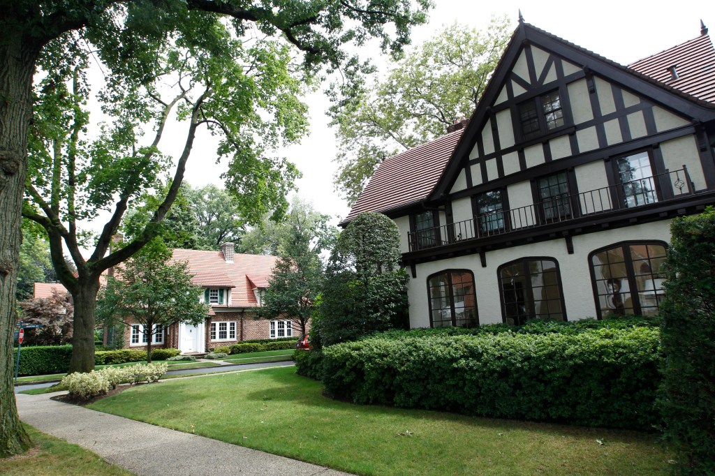 Tudor-style residential house with a lawn and trees in Forest Hills Gardens, New York