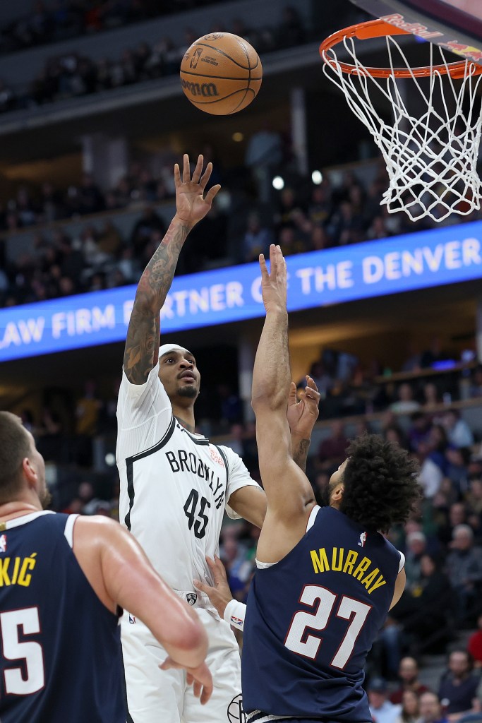  Keon Johnson #45 of the Brooklyn Nets puts up a shot over Jamal Murray #27 of the Denver Nuggets in the first quarter at Ball Arena on January 10, 2025 in Denver, Colorado.