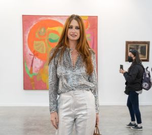 Photo of a young woman with red hair in an art fair.