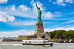 Statue of Liberty and tourist ship ferry in New York City, NY, USA