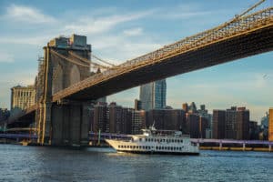 NEW YORK - NOVEMBER 29, 2020: Yacht Manhattan II Cruise Boat under Brooklyn Bridge