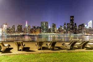 Benches along Gantry Park with the New York City skyline view in the background.