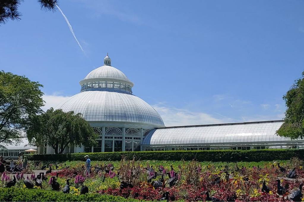 The facade of New York Botanical Gardens- a dome and flowers.