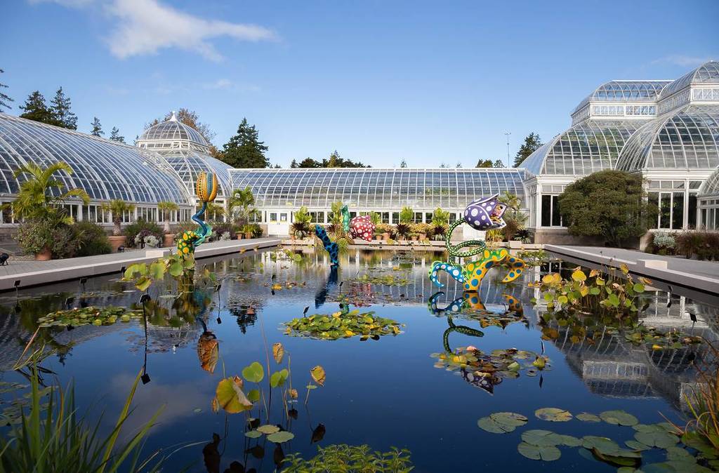 The Greenhouse-like New York Botanical Garden behind a large pond.