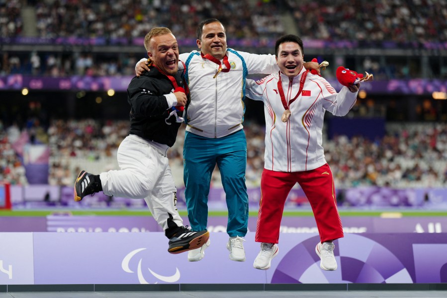 Silver medallist Germany's Niko Kappel Gold medallist Uzbekistan's Bobirjon Omonov and Bronze medallist Bronze medallist China's Jun Huang celebrate on the podium during the medal ceremony for the Men's F41 Shot Put Final at the Paris 2024 Paralympic Games in the Stade de France Saint-Denis north of Paris on September 2 2024