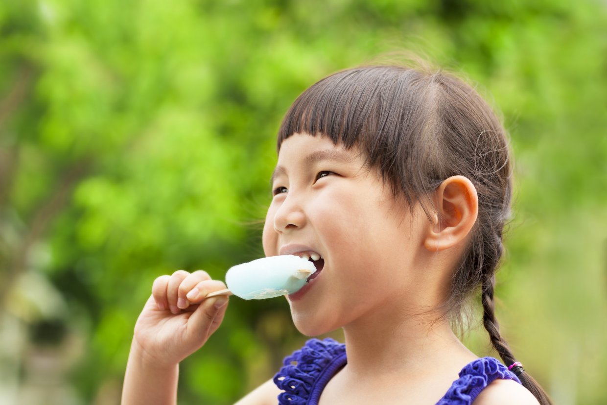 Happy,Little,Girl,Eating,Popsicle,At,Summertime