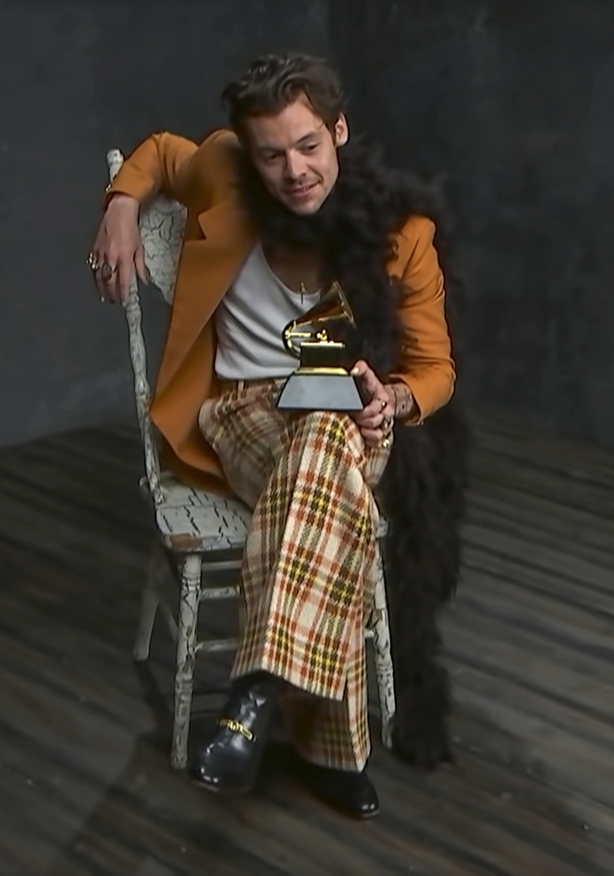 Harry Styles poses with his Best Pop Solo Performance Grammys — and, yes, another boa.