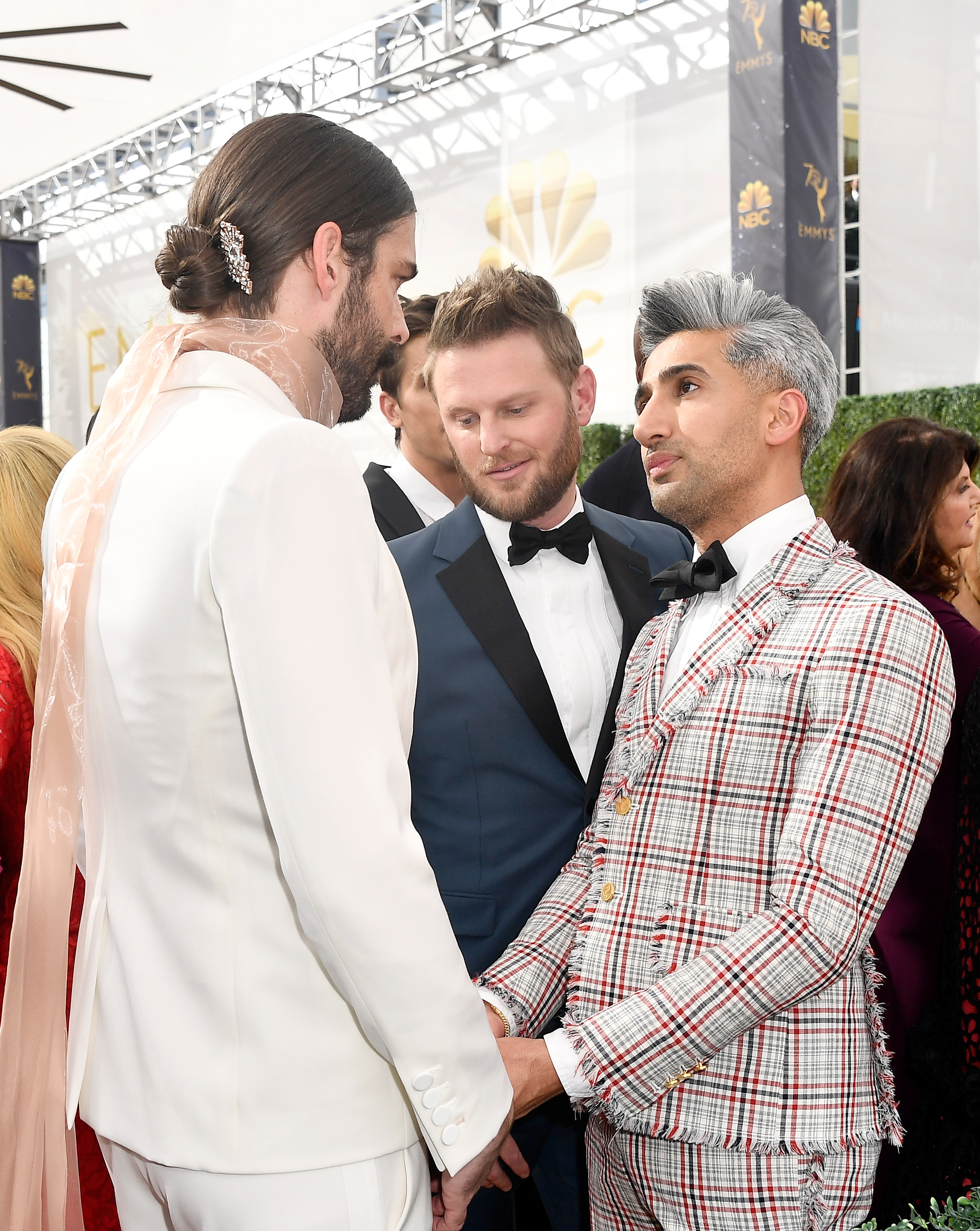 Tan France chatting with Jonathan Van Ness with Bobby Berk present.