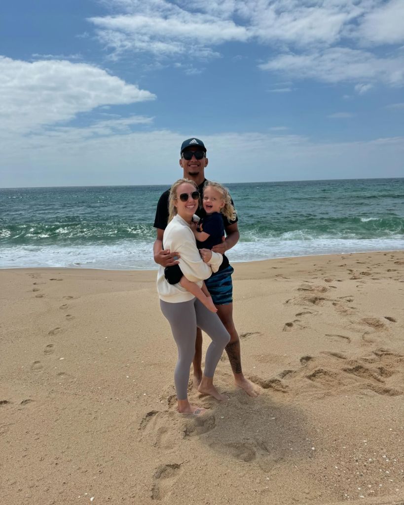 Patrick and Brittany Mahomes on the beach with Sterling. 