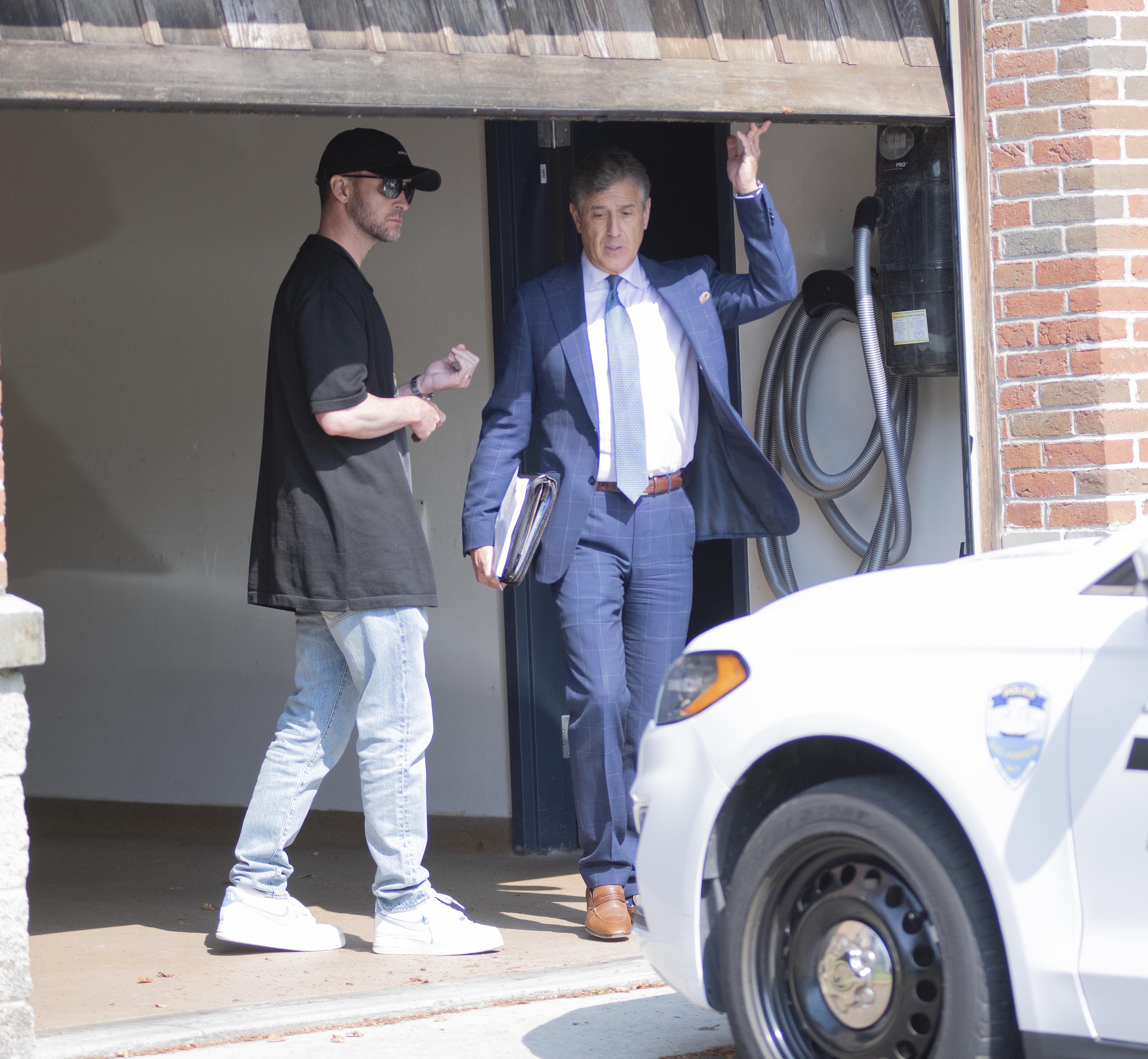 Justin Timberlake and Edward Burke Jr. leaving the police department.