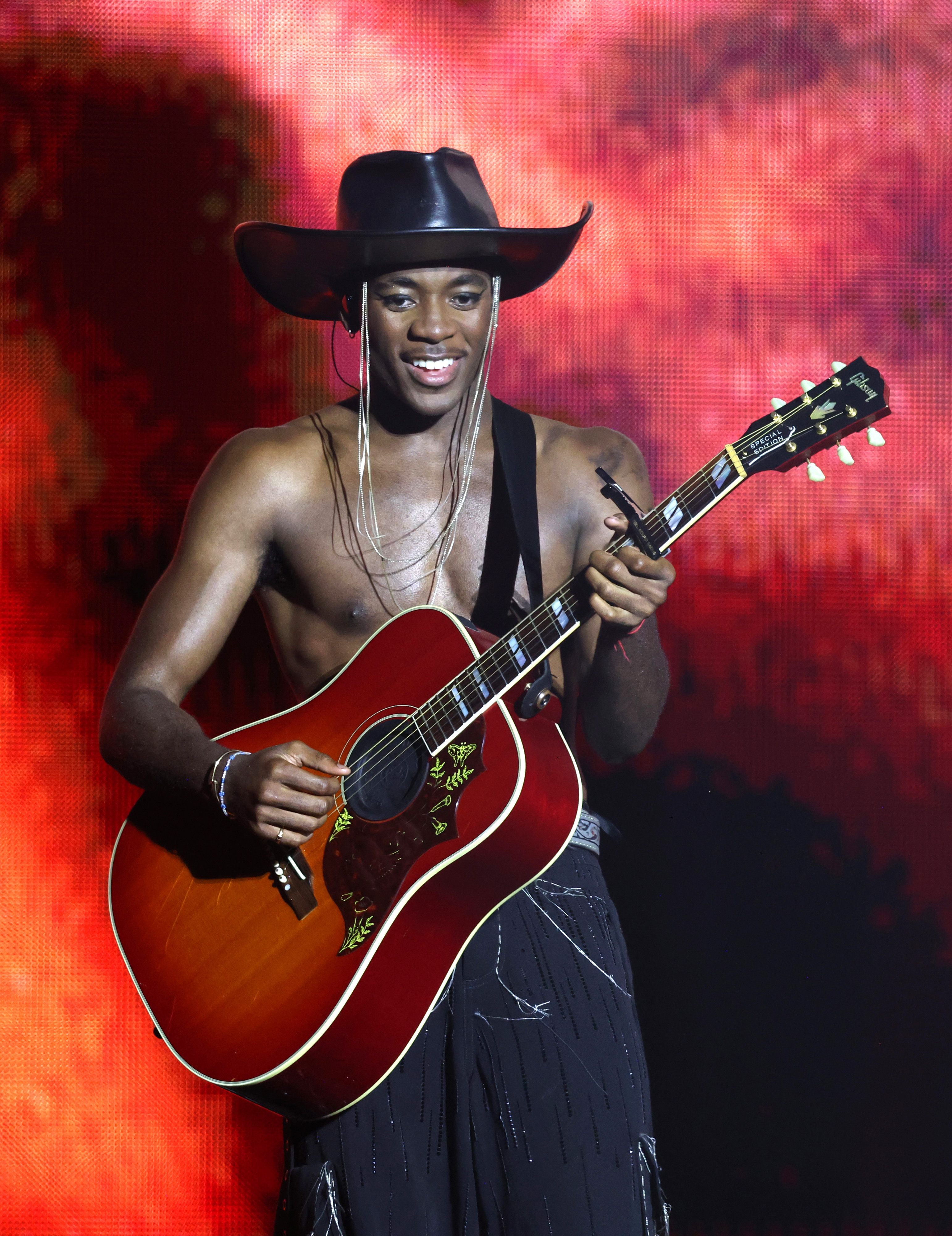 shirtless david banda playing guitar