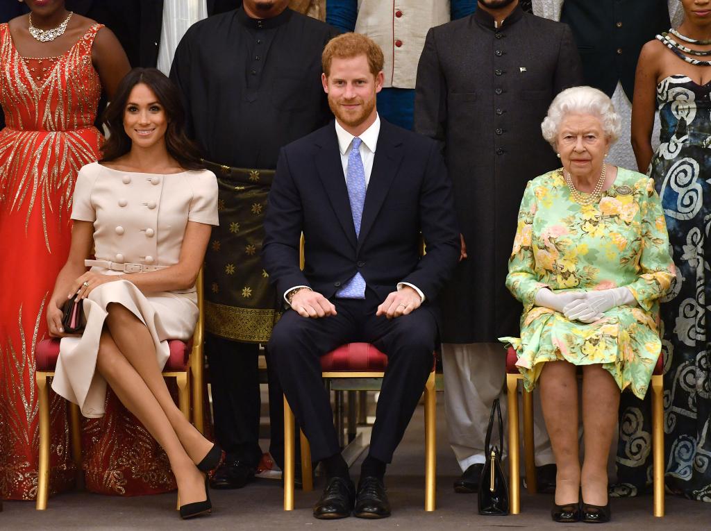 Prince Harry sits with Queen Elizabeth II, and Meghan Markle in June 2018.