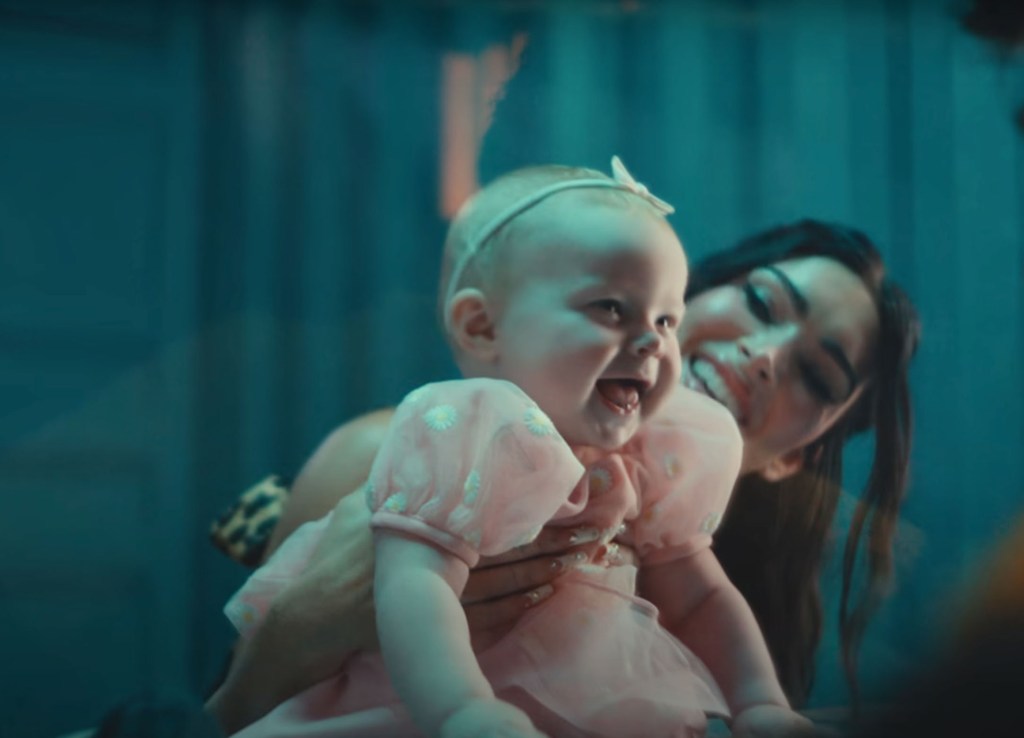 Fox held up a baby girl at the end of the "Lonely Road" music video, out Friday.