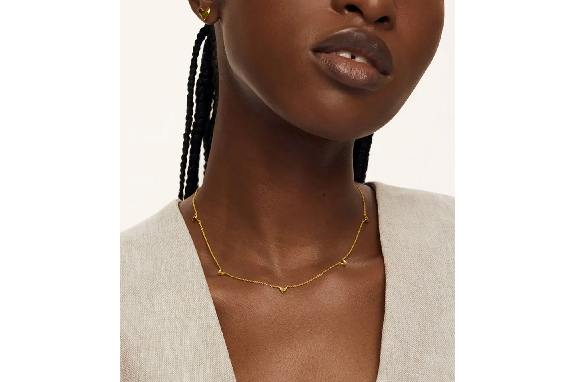 A model in a dainty gold necklace