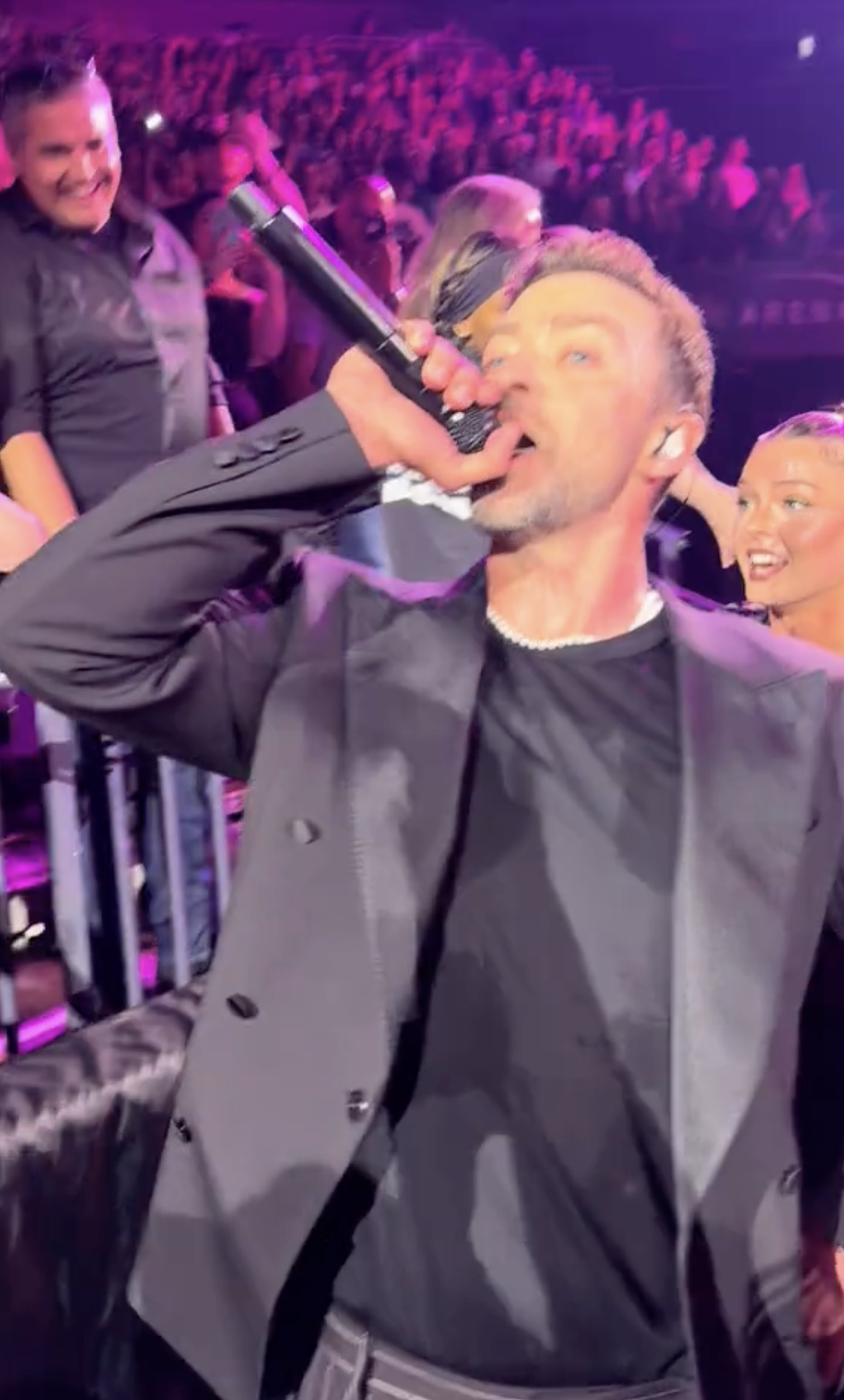 Justin Timberlake performing for fans at his concert.