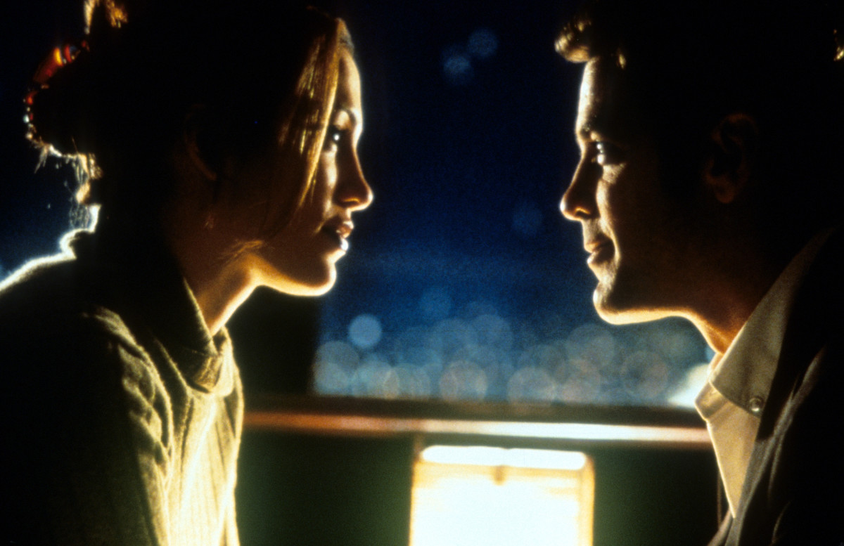 Jennifer Lopez net worth - Jennifer Lopez and George Clooney looking romantically at each other in a scene from the film 'Out Of Sight', 1998. (Photo by Universal/Getty Images)