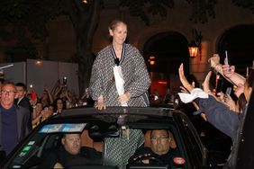 Celine Dion in full Dior creates a crowd movement as she exits through the roof of her car leaving her hotel in Paris followed by her fans.