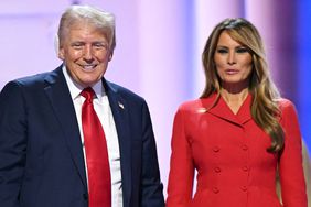 Former US President and 2024 Republican presidential candidate Donald Trump holds hands with former First Lady Melania Trump