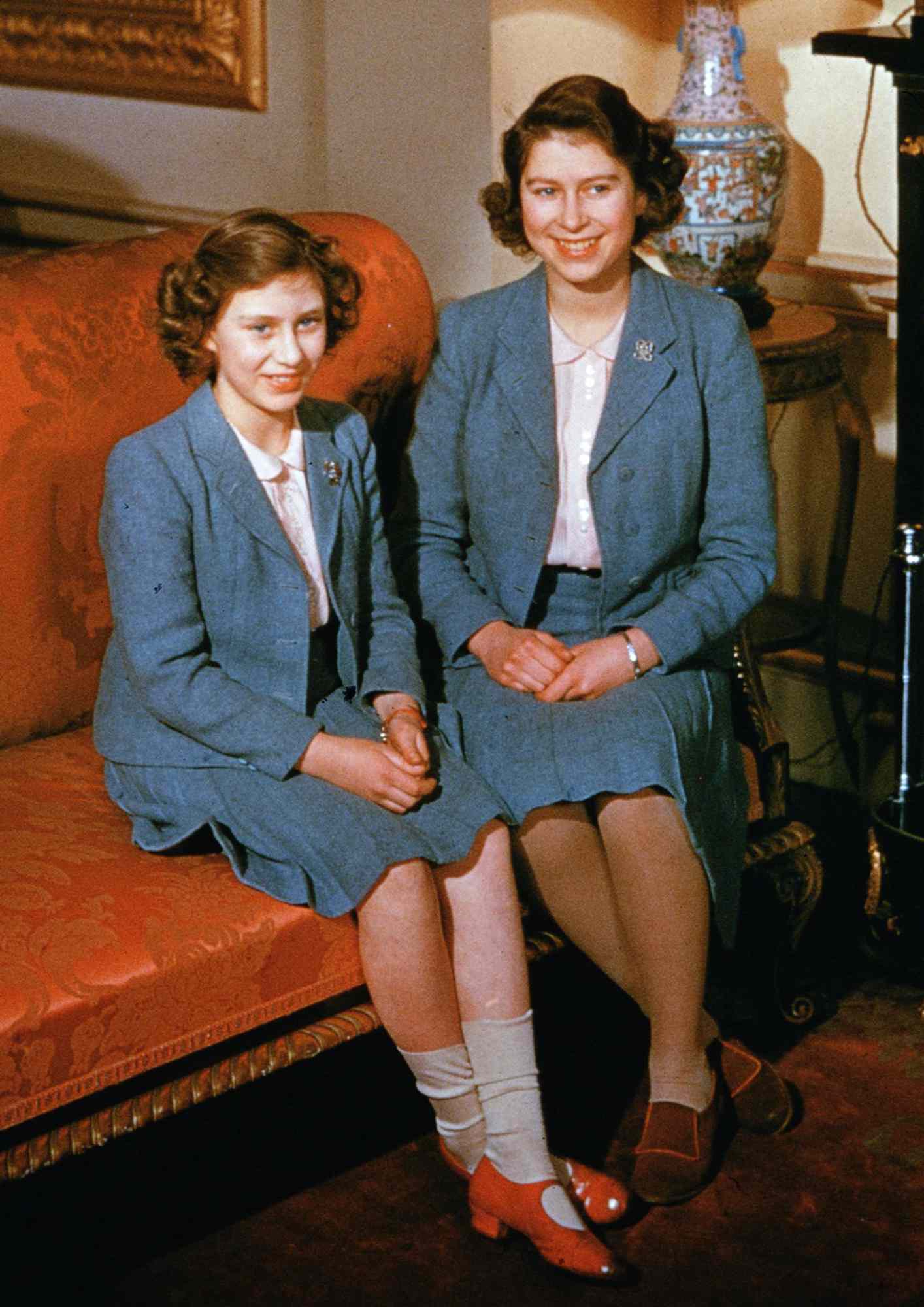 Princess Elizabeth and Princess Margaret (1930 - 2002) wearing matching outfits at Buckingham Palace