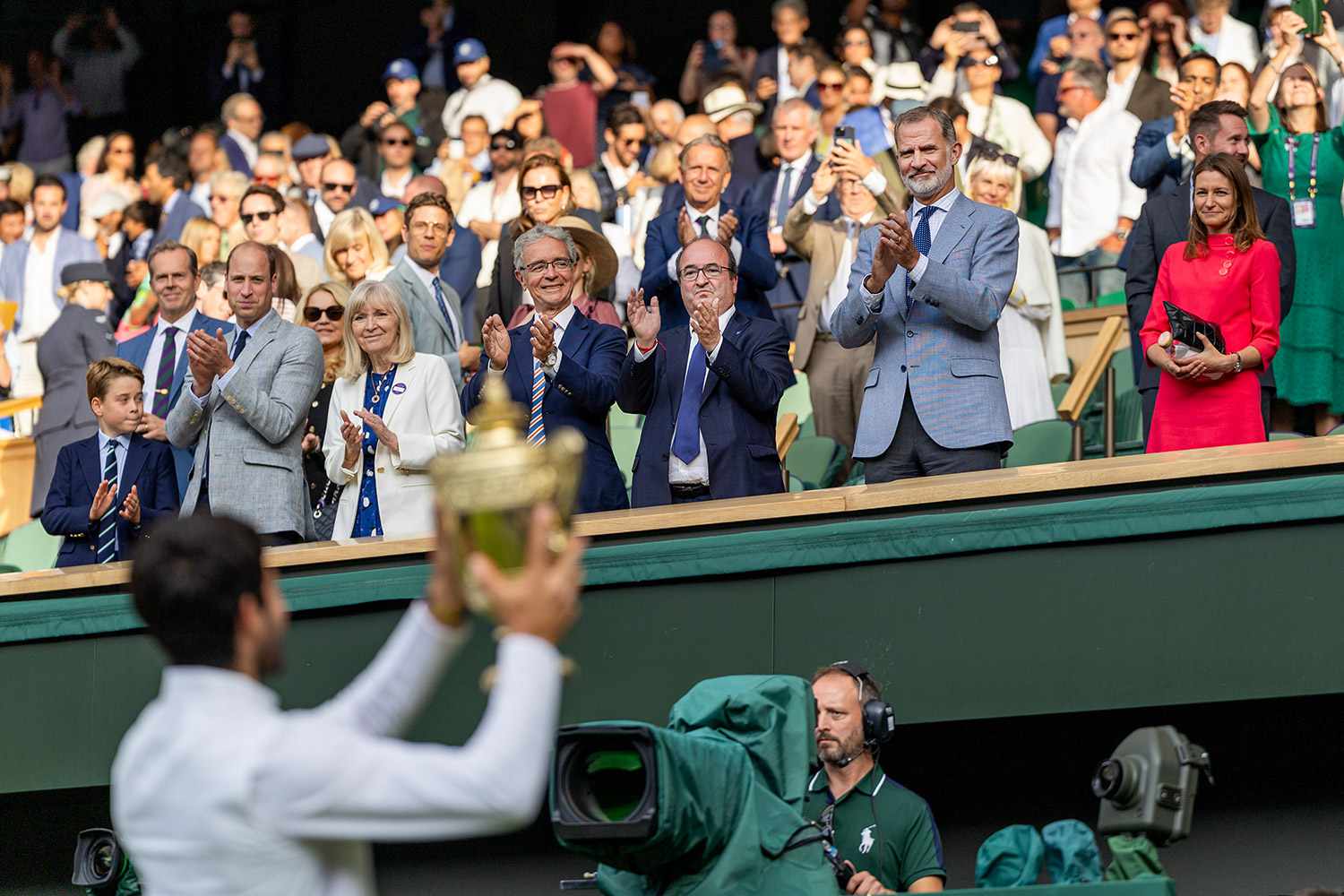 Carlos Alcaraz of Spain with the winners trophy is applauded by King Felipe of Spain after his victory against Novak Djokovic of Serbia in the Gentlemen's Singles Final match on Centre Court during the Wimbledon Lawn Tennis Championships at the All England Lawn Tennis and Croquet Club at Wimbledon on July 16, 2023