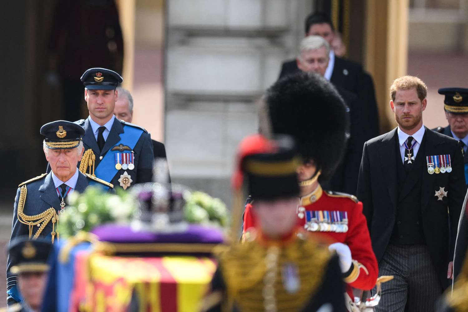 King Charles III (L), Britain's Prince William, Prince of Wales (2L) and Britain's Prince Harry, Duke of Sussex walk behind the coffin of Queen Elizabeth II