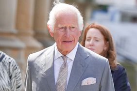 King Charles III gestures as he visits Southport to meet local community and emergency services in Southport