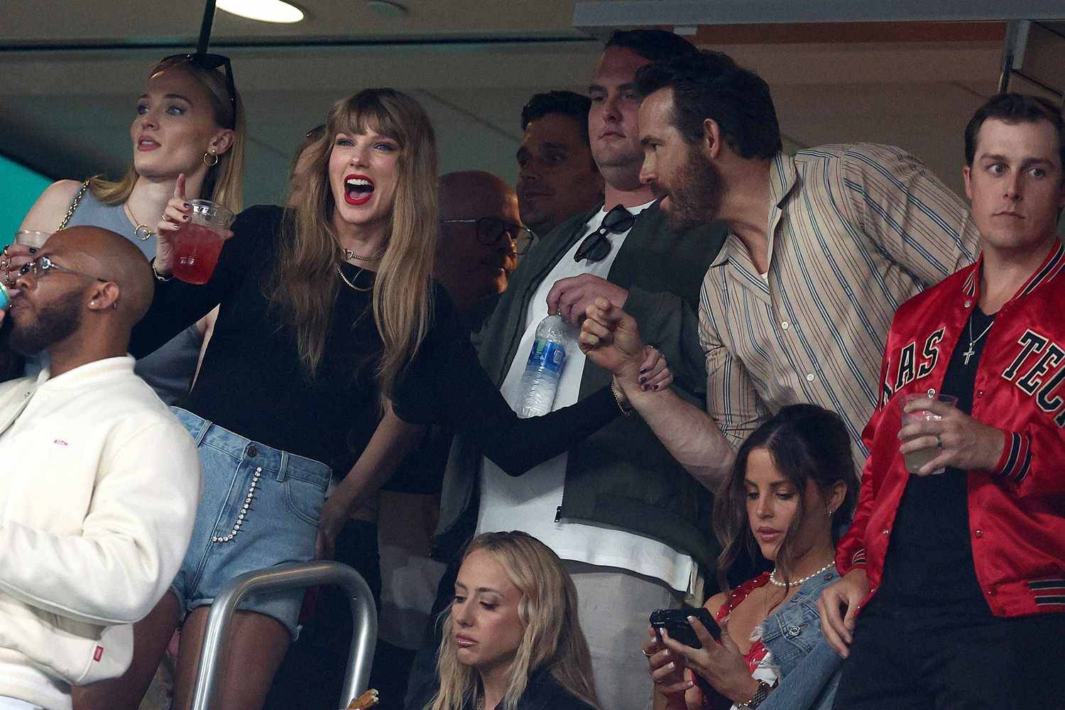 Taylor Swift and Actor Ryan Reynolds talk prior to the game between the Kansas City Chiefs 