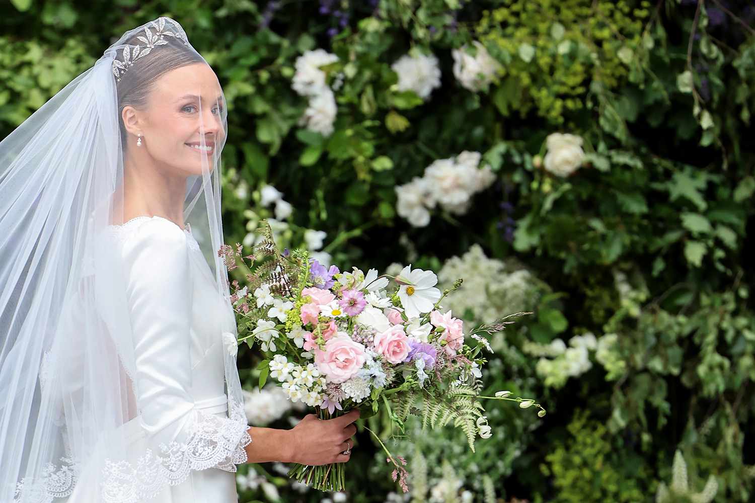 Olivia Henson carries her bouquet of flowers as she arrives for her wedding to Hugh Grosvenor, Duke of Westminster at Chester Cathedral 