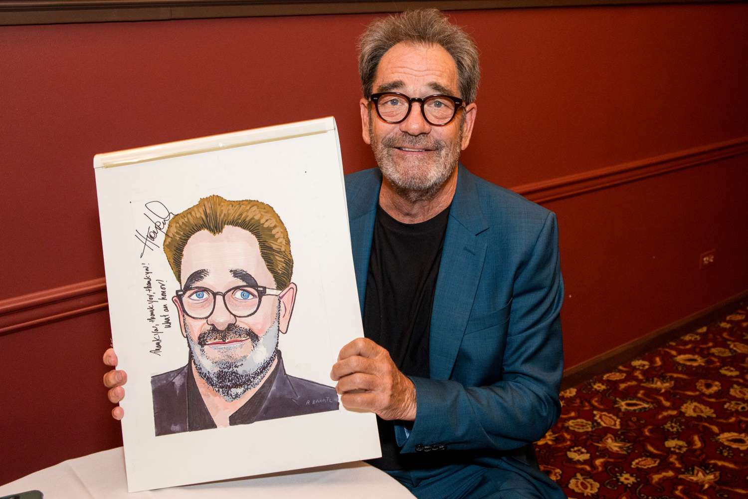 Huey Lewis was honored with a caricature for the walls of famed Broadway restaurant