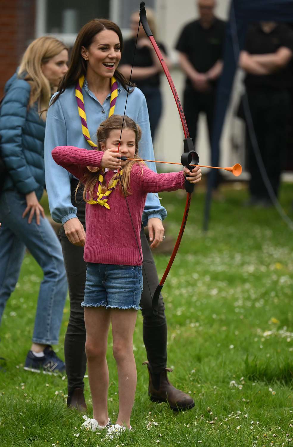 Watched by her mother Catherine, Princess of Wales, Princess Charlotte of Wales tries her hand at archery 