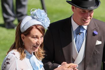 Carole Middleton holds hands with Prince William, Prince of Wales as they attend day two of Royal Ascot 2024
