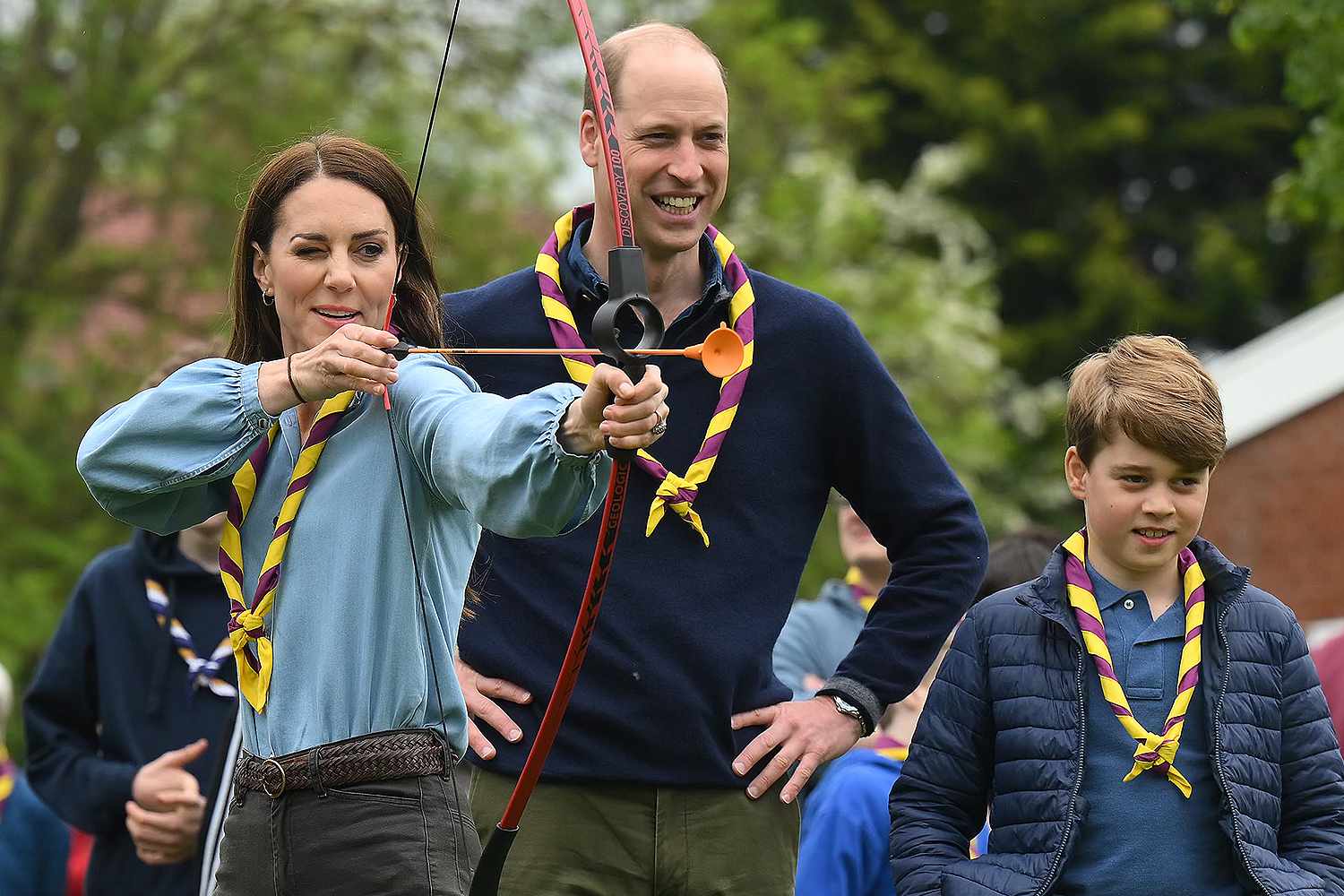  Watched by Prince William, Prince of Wales (centre right) and Prince George of Wales (R), Britain's Catherine, Princess of Wales, tries her hand at archery while taking part in the Big Help Out, during a visit to the 3rd Upton Scouts Hut in Slough on May 8, 2023 in London, England. The Big Help Out is a day when people are encouraged to volunteer in their communities. It is part of the celebrations of the Coronation of Charles III and his wife, Camilla, as King and Queen of the United Kingdom of Great Britain and Northern Ireland, and the other Commonwealth realms that took place at Westminster Abbey on Saturday, May 6, 2023.