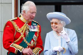 Prince Charles, Prince of Wales (wearing the uniform of Colonel of the Welsh Guards) and Queen Elizabeth II watch a flypast from the balcony of Buckingham Palace during Trooping the Colour on June 2, 2022