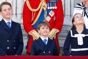 Prince George of Wales, Prince Louis of Wales and Princess Charlotte of Wales watch an RAF flypast from the balcony of Buckingham Palace after attending Trooping the Colour 