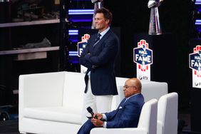 FOXBOROUGH, MASSACHUSETTS - JUNE 12: Tom Brady and Mike Tirico look on during the 2024 Hall of Fame Induction Ceremony for Tom Brady at Gillette Stadium on June 12, 2024 in Foxborough, Massachusetts.